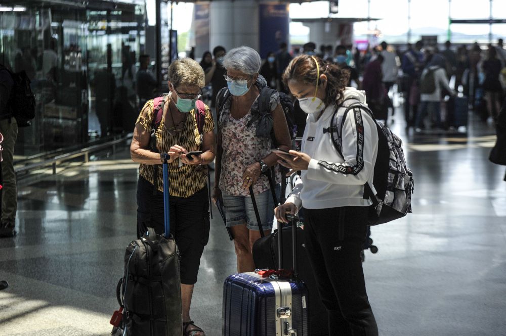 Travellers are pictured at the Kuala Lumpur International Airport in Sepang March 17, 2020. u00e2u20acu201d Picture by Shafwan Zaidon