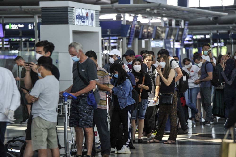 Travellers are pictured at the Kuala Lumpur International Airport in Sepang March 17, 2020. u00e2u20acu201d Picture by Shafwan Zaidon