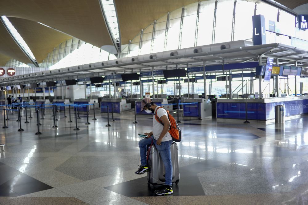 A man wearing a face mask is pictured at the Kuala Lumpur International Airport in Sepang March 18, 2020. u00e2u20acu201d Picture by Shafwan Zaidon