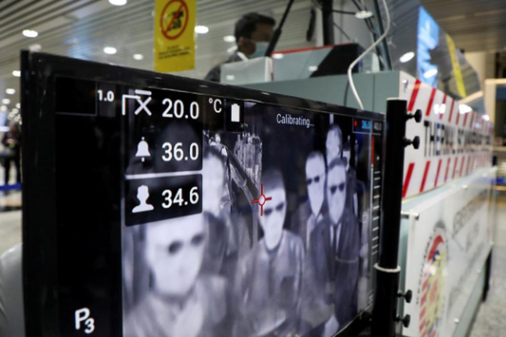 A health quarantine officer waits for passengers at a thermal screening point in the international arrivals terminal of Kuala Lumpur International Airport in Sepang, March 10, 2020. u00e2u20acu201d Reuters pic