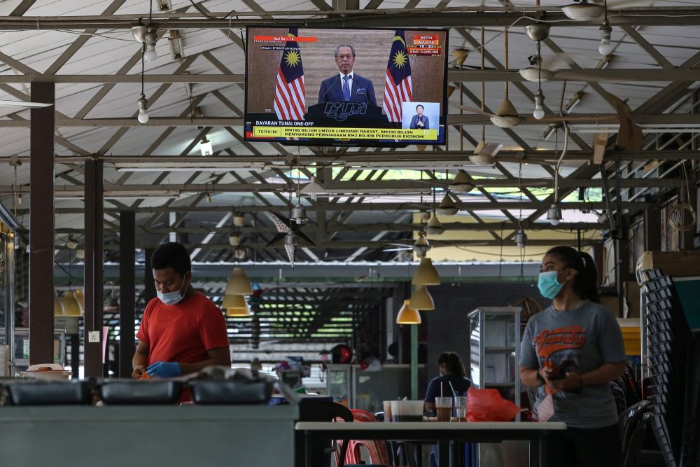 A live broadcast of Prime Minister Tan Sri Muhyiddin Yassin on the special Covid-19 stimulus package is seen on a television in Kuala Lumpur March 27, 2020. u00e2u20acu2022 Picture by Yusof Mat Isa