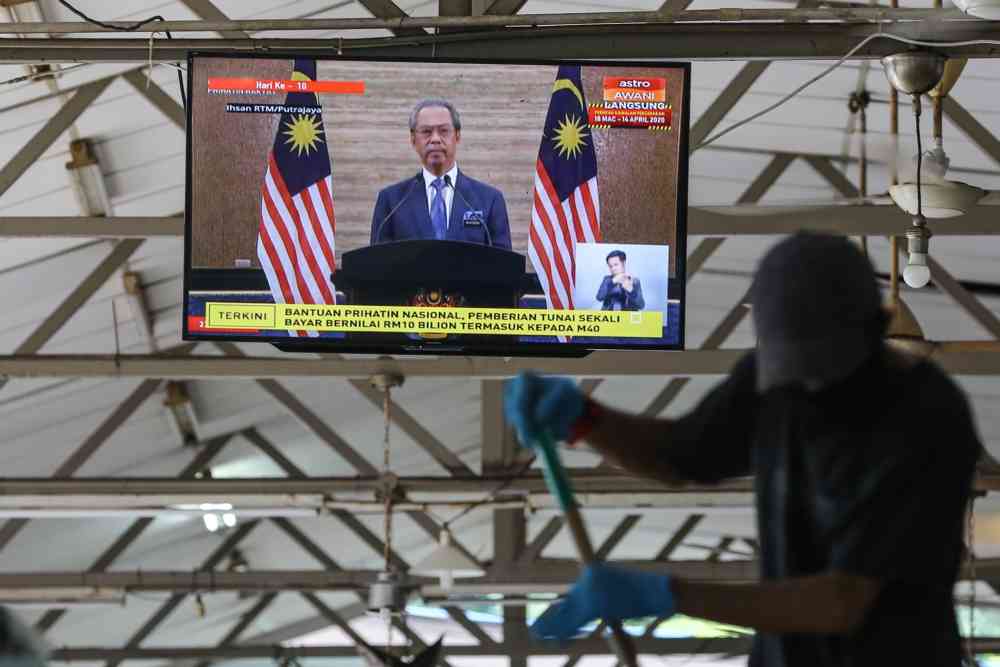 A live broadcast of Prime Minister Tan Sri Muhyiddin Yassin on the special Covid-19 stimulus package is seen on a television in Kuala Lumpur March 27, 2020. u00e2u20acu2022 Picture by Yusof Mat Isa