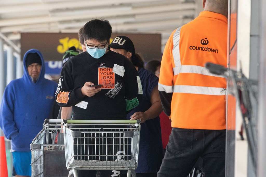 A man wearing a face mask to waits enter a supermarket to buy supplies one day before New Zealand goes on lockdown in Wellington March 24, 2020. u00e2u20acu201d AFP pic