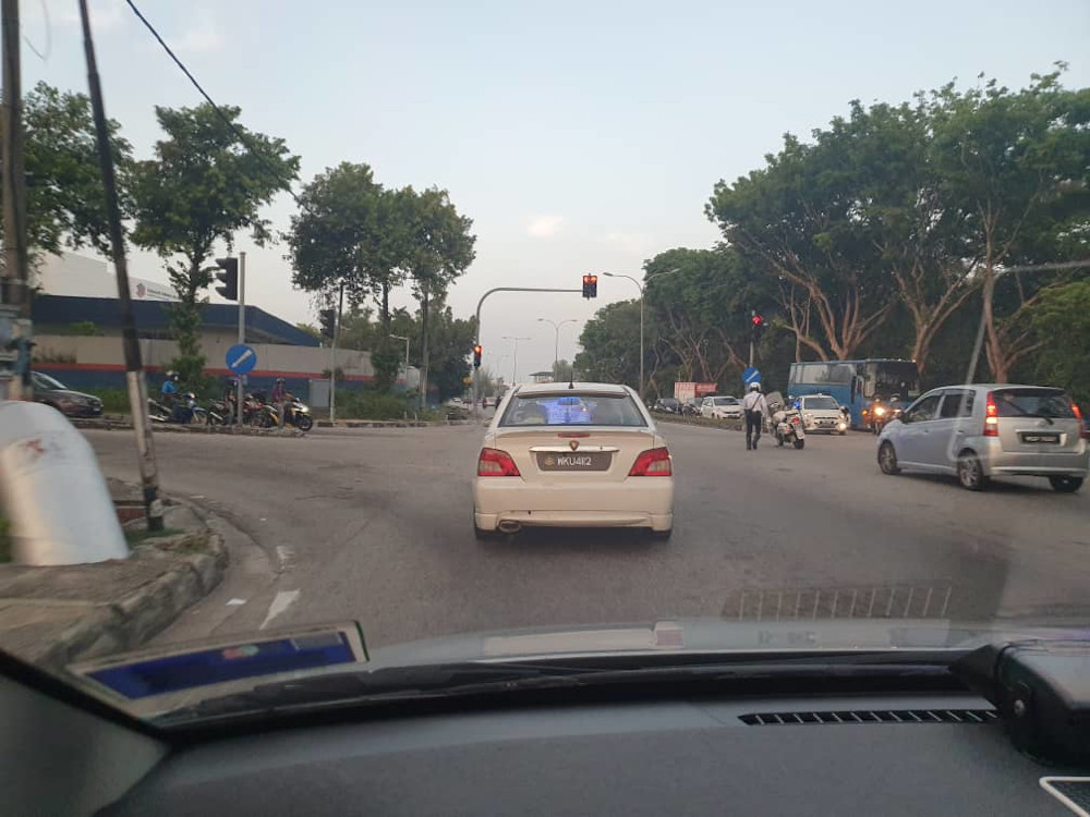 The police escorting the car (front) to the Bayan Baru clinic March 20, 2020. u00e2u20acu201d Picture courtesy of Royal Malaysian Police