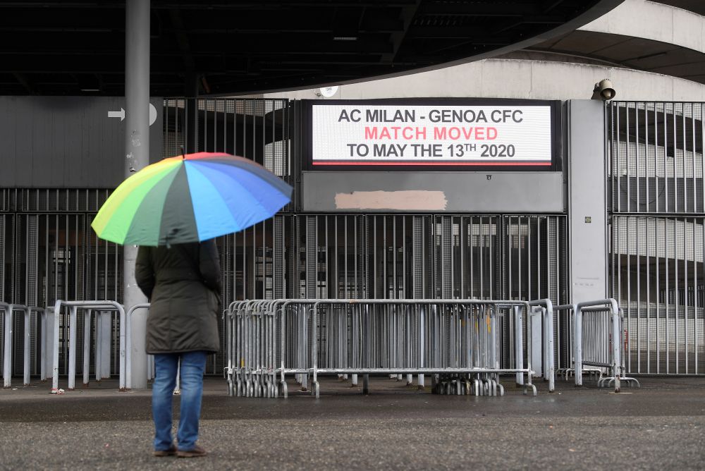 A woman is seen outside the San Siro stadium after the Serie A match AC Milan v Genoa was postponed due to the recent coronavirus outbreak. u00e2u20acu201d Reuters pic