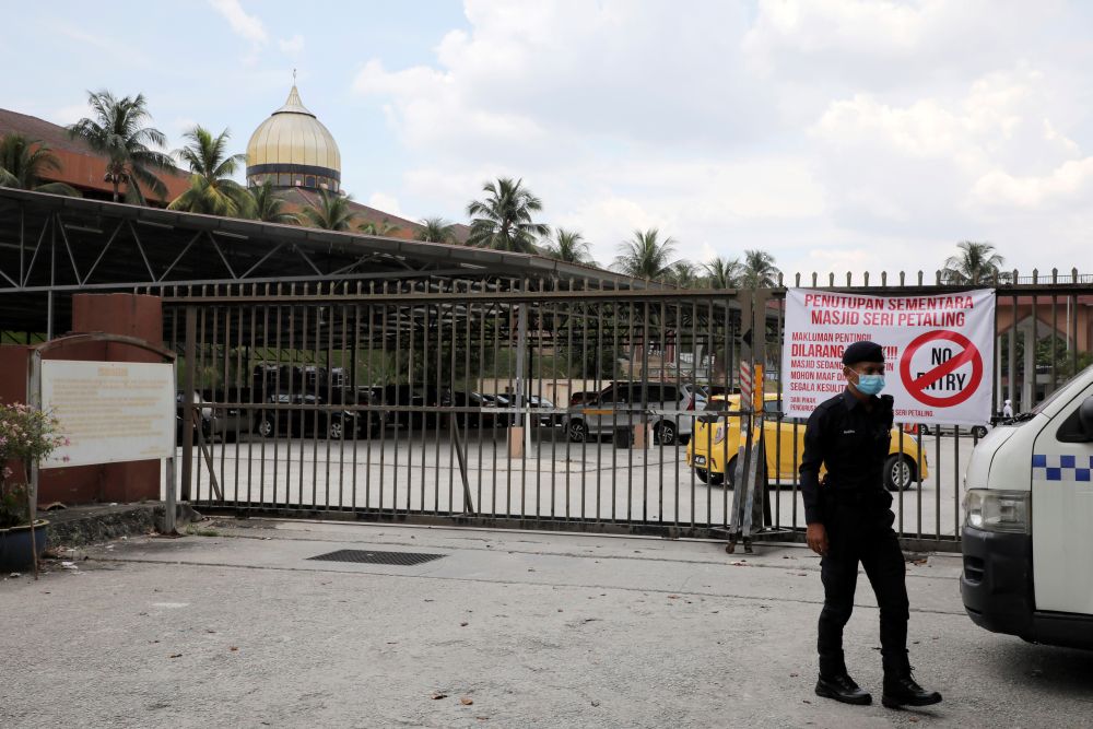 A police officer wearing protective mask stands guard outside the Sri Petaling Mosque, which has emerged as a source of hundreds of new coronavirus disease infections spanning across South-east Asia March 18, 2020. u00e2u20acu201d Reuters picnn