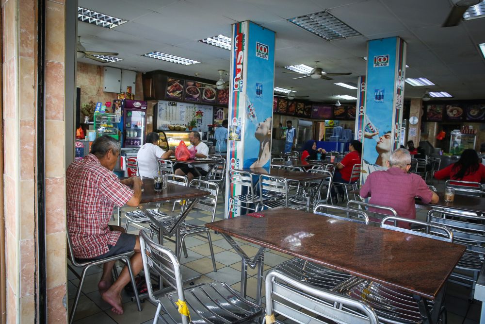 Patrons are pictured at an restaurant in Subang Jaya as the movement control order kicks in on March 18, 2020. u00e2u20acu201d Picture by Yusof Mat Isa