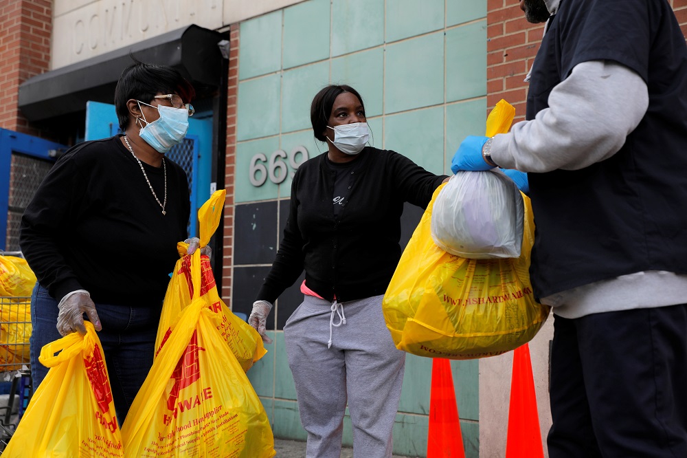 Volunteers with the Central Harlem NYCHA distribute food packs at the Frederick E. Samuel Community Centre during the coronavirus disease outbreak in Harlem, New York April 2, 2020. u00e2u20acu201d Reuters pic