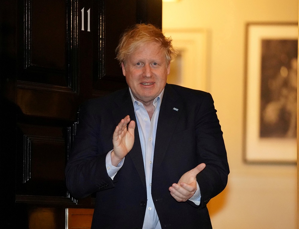 Britain's Prime Minister Boris Johnson applauds in support of the NHS during Clap for our Carers, outside 11 Downing Street in London April 2, 2020. u00e2u20acu201dPippa Fowles/10 Downing Street/Handout via Reuters