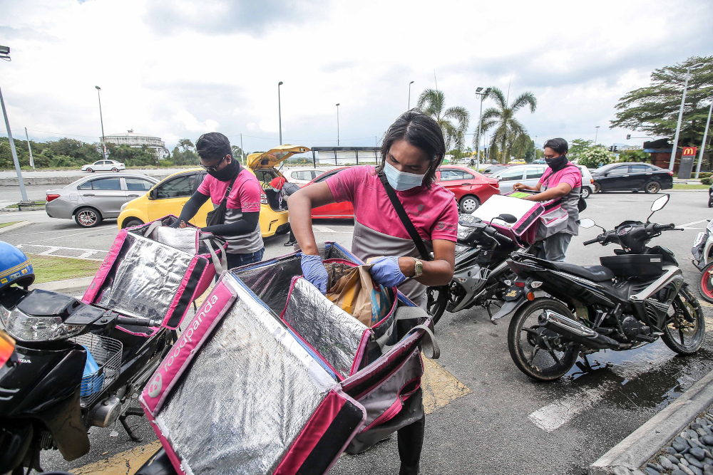 Food delivery riders at work in Ipoh as the second phase of the movement control order (MCO) April 3, 2020. u00e2u20acu201d Picture by Farhan Najib