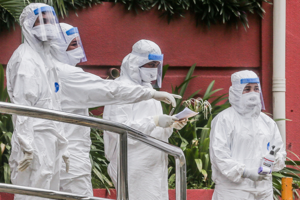 Health workers are seen at Menara City One during the enhanced movement control order (EMCO) in Kuala Lumpur April 5, 2020. u00e2u20acu201d Picture by Firdaus Latif