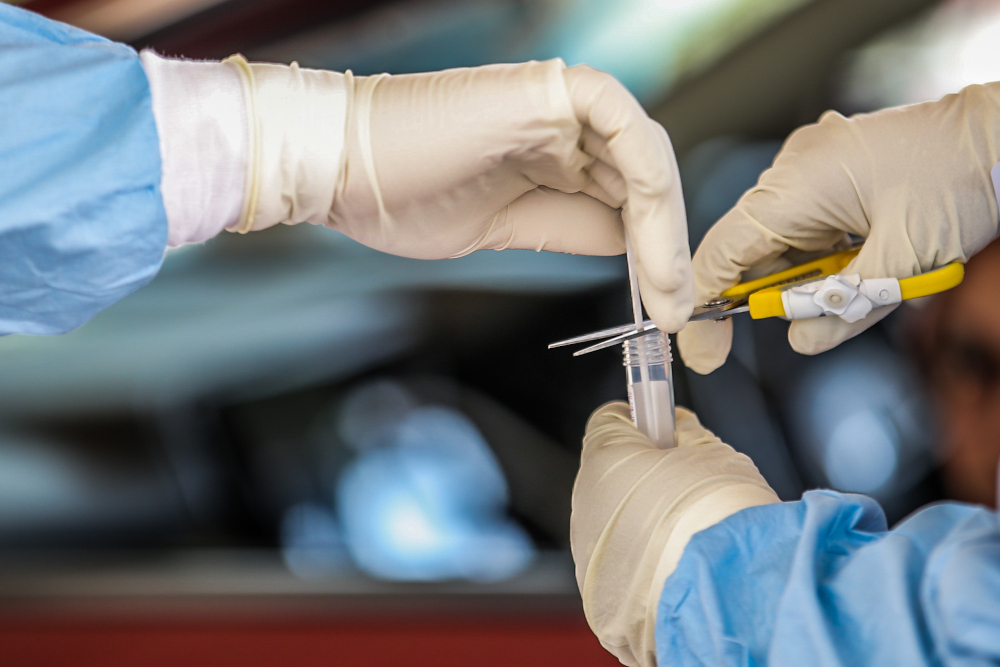 A medical worker takes a swab at a Covid-19 drive-through screening area at KPJ Ampang Puteri April 9, 2020. u00e2u20acu201d Picture by Hari Anggara