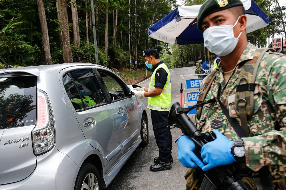 Policemen and Army personnel join forces to man the roadblocks at the entrance and exits to Balik Pulau at Jalan Tun Sardon in Penang April 10, 2020. u00e2u20acu201d Picture by Sayuti Zainudin