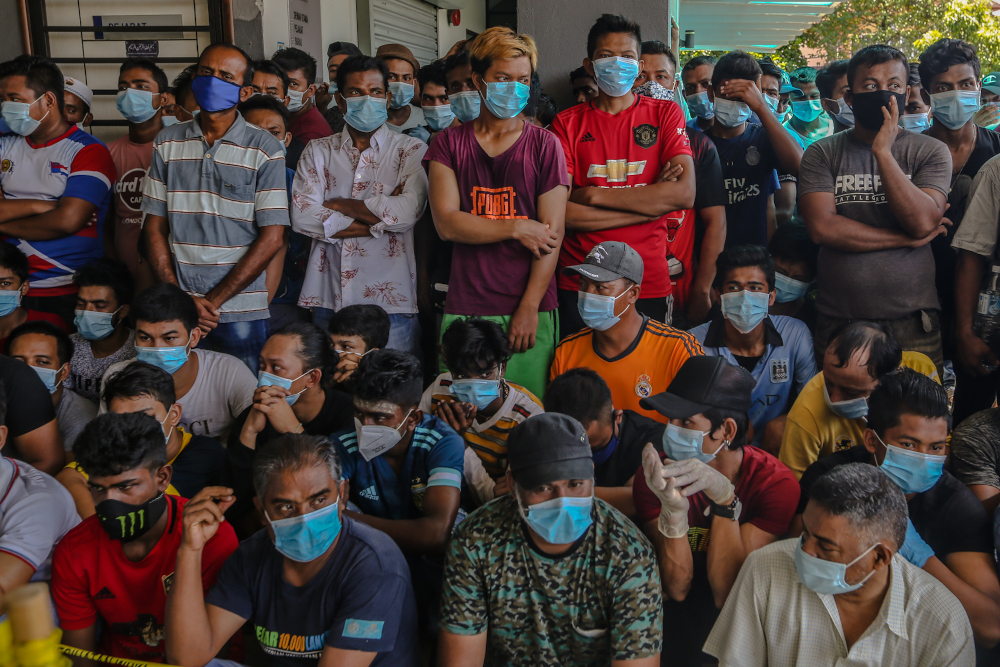 Foreign workers are seen during Covid-19 testing in Kuala Lumpur April 12, 2020. u00e2u20acu201d Picture by Firdaus Latif 