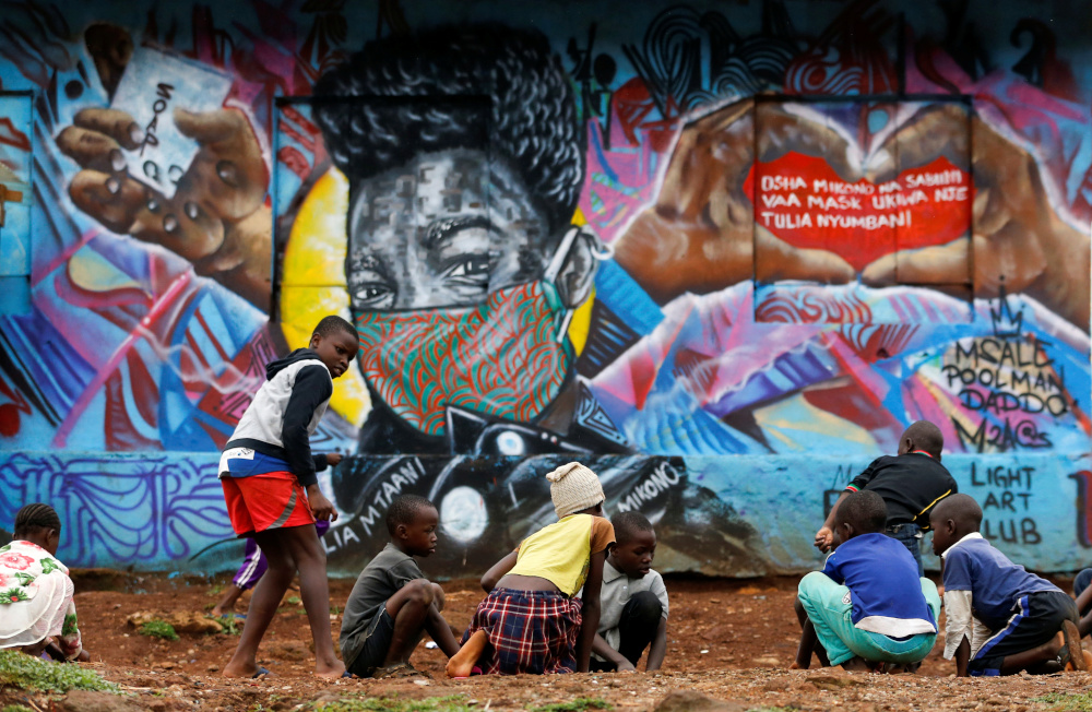 Children play in front of a graffiti by Mathare Roots's youth group that advocates against the spread of the coronavirus disease, at the Mathare Valley slum, in Nairobi, Kenya April 19, 2020. u00e2u20acu201d Reuters pic 