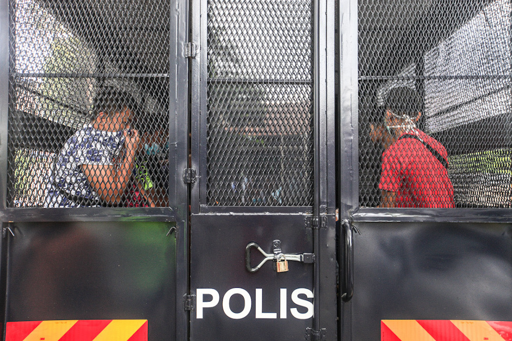 The 13 people detained for gathering in a barber shop during the movement control order in Butterworth April 27, 2020 are taken away by police. u00e2u20acu201d Picture by Sayuti Zainudin