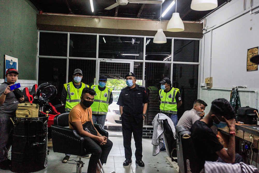 Northern Seberang Perai Police Chief ACP Noorzainy Mohd Noor looks on after their operation caught 13 people gathering in a barber shop here at Butterworth April 27, 2020. u00e2u20acu201d Picture by Sayuti Zainudin