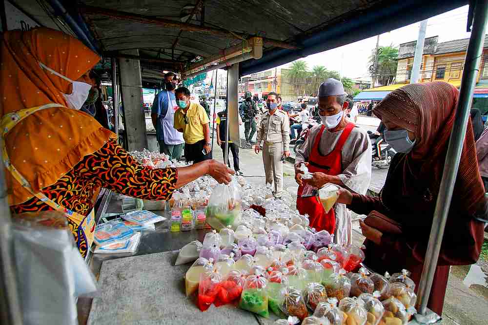 People wearing protective face masks shop for food during the holy fasting month of Ramadan, amid the Covid-19 outbreak, in Yala province, Thailand April 27, 2020. u00e2u20acu201d Reuters pic