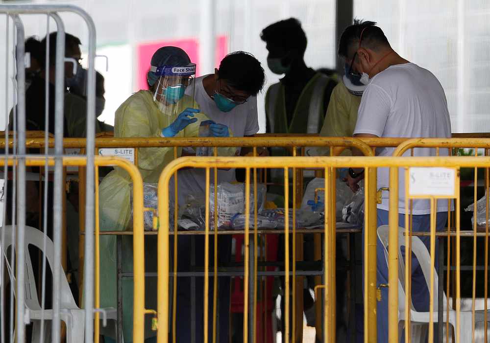 Medical personnel sort out medical supplies at a dormitory during the Covid-19 outbreak in Singapore April 20, 2020. u00e2u20acu201d Reuters pic