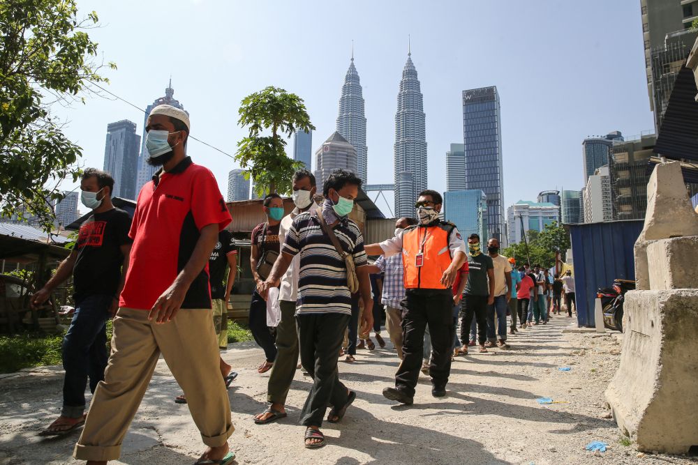 Foreign workers queue up to be tested for Covid-19 at Kampung Baru, Kuala Lumpur April 16, 2020. u00e2u20acu201d Picture by Yusof Mat Isa