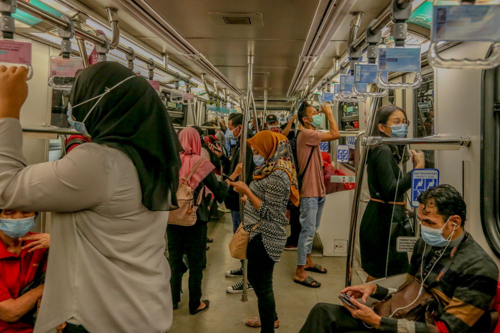 Commuters are pictured aboard an LRT train during rush hour in Kuala Lumpur April 28, 2020. u00e2u20acu201d Picture by Firdaus Latif