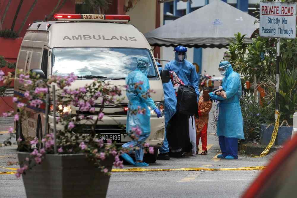 A family from Menara City One, believed to be Covid-19 positive, is being transferred to Hospital Kuala Lumpur for further treatment, April 4, 2020. u00e2u20acu2022 Picture by Ahmad Zamzahuri