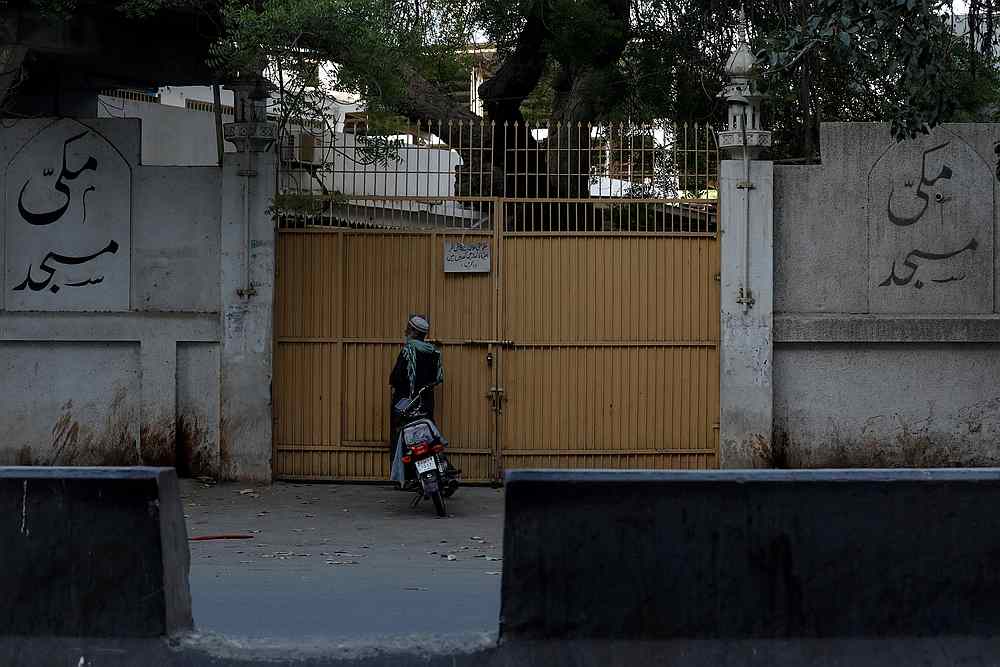 A man stands at the closed entrance of the Makki Masjid Tablighi centre, after Pakistan ordered to quarantine the centre, following the Covid-19 outbreak, in Karachi March 31, 2020. u00e2u20acu201d Reuters pic