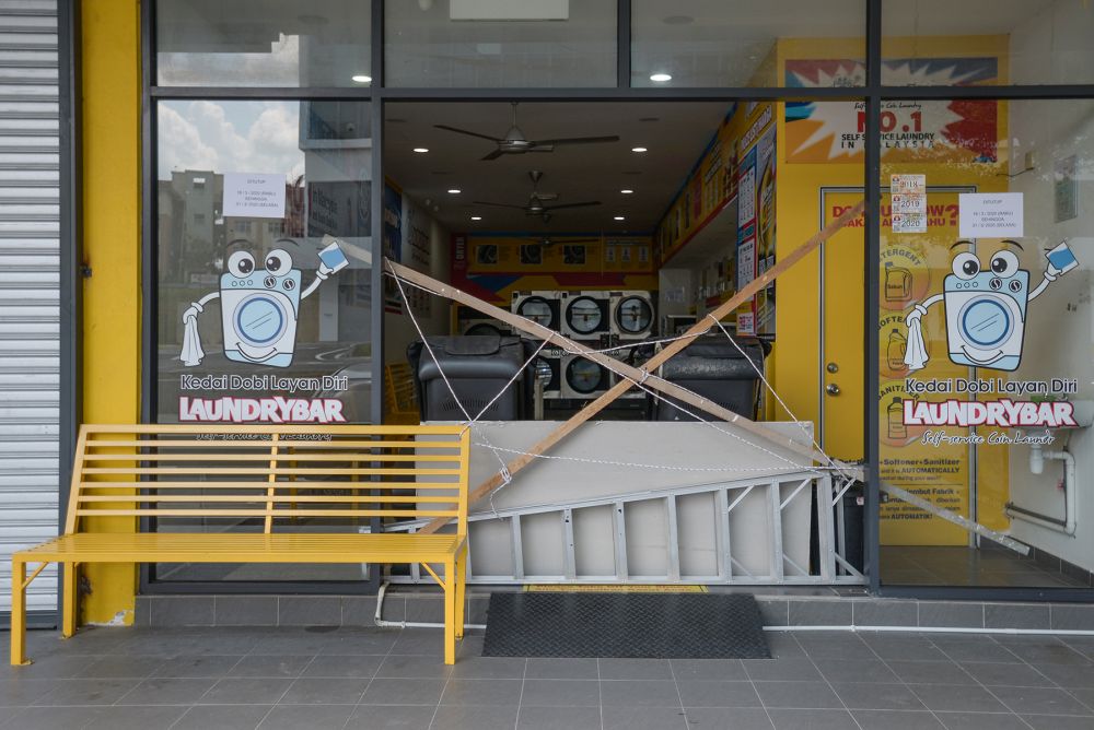 A self-service laundrette in Shah Alam is cordoned off from the public as the movement control order enters phase three on April 15, 2020. u00e2u20acu201d Picture by Miera Zulyana