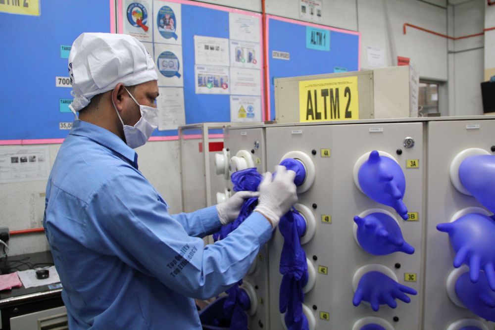 A worker inspects newly made gloves at Top Glove factory in Klang March 3, 2020. u00e2u20acu201d Reuters pic