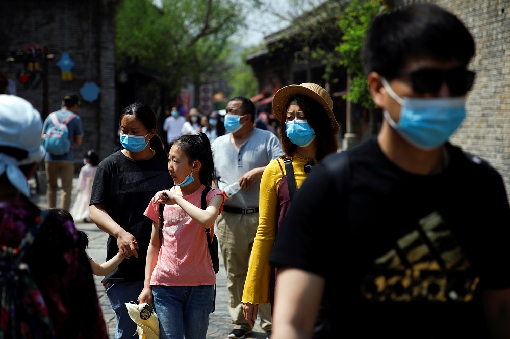People wearing face masks visit Gubei Water Town on the first day of the five-day Labour Day holiday, following the coronavirus disease outbreak, on the outskirts of Beijing May 1, 2020. u00e2u20acu201d Reuters pic