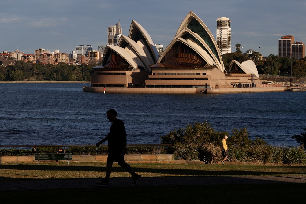 People stroll through a park in front of the Sydney Opera House amidst the easing of the coronavirus disease restrictions in Sydney May 20, 2020. u00e2u20acu201d Reuters pic