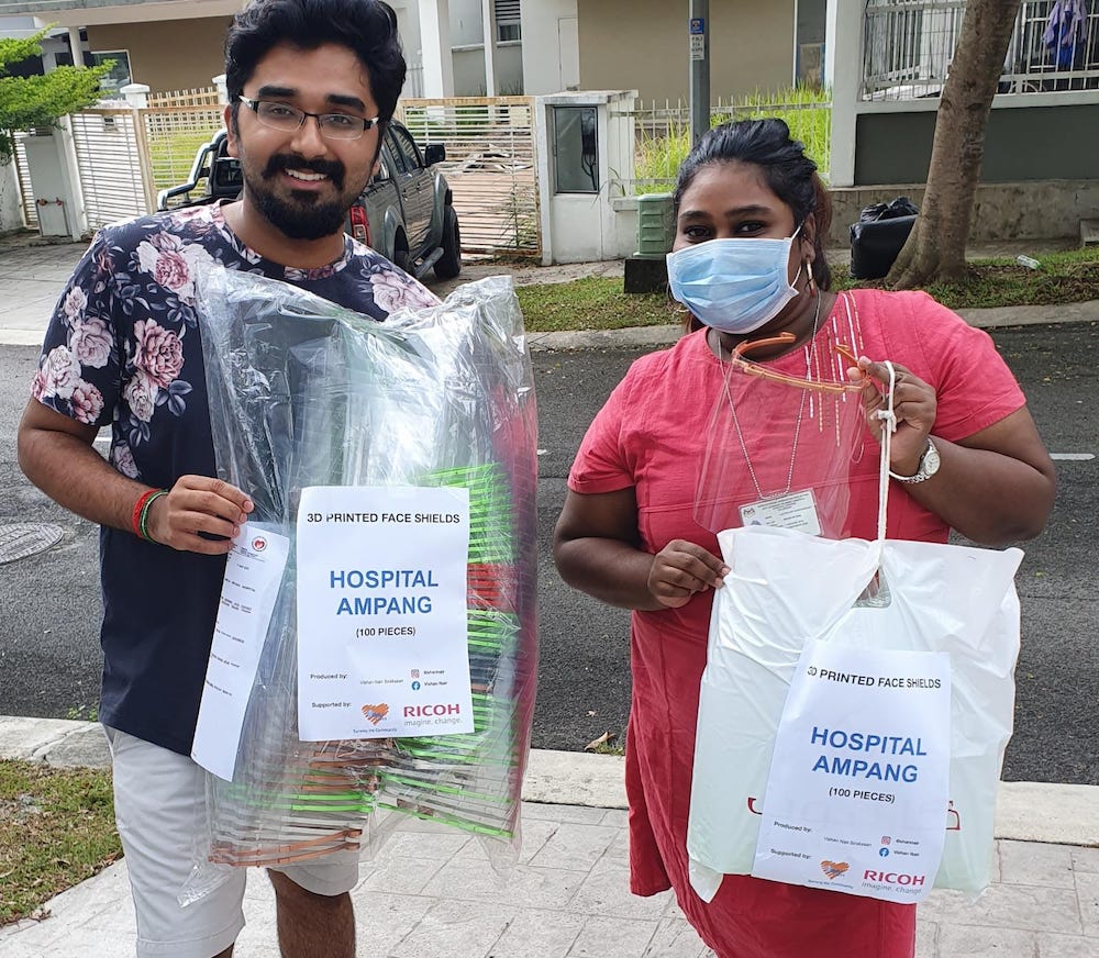 Vishan delivering 100 face shields to a volunteer to be distributed to Ampang Hospital. u00e2u20acu201d Picture by Vishan Nair.