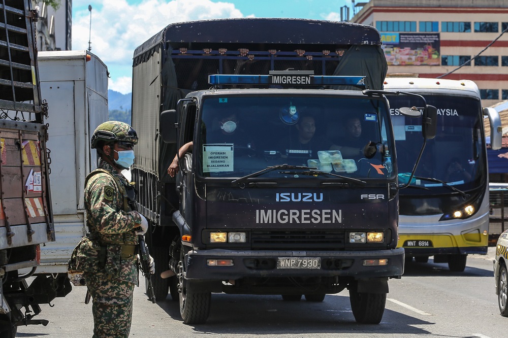 Illegal immigrants are detained by the Immigration Department following raids carried out at Selayang Baru in Kuala Lumpur May 14, 2020. u00e2u20acu201d Picture by Yusof Mat Isa
