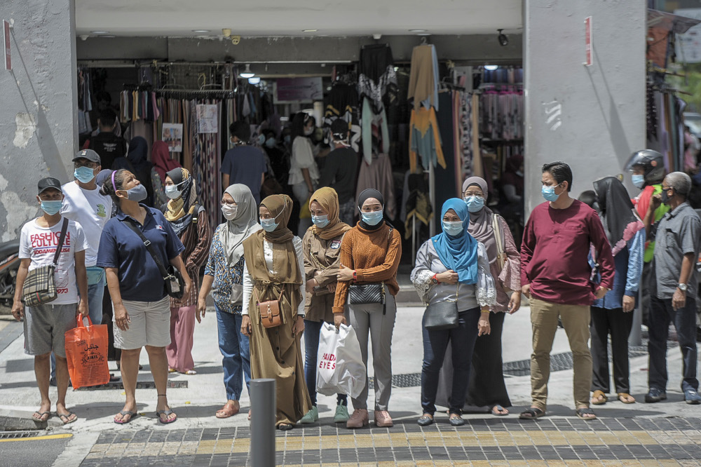 People are seen wearing masks as they go shopping at Jalan Tunku Abdul Rahman in Kuala Lumpur, May 17, 2020. u00e2u20acu201d Picture by Shafwan Zaidon