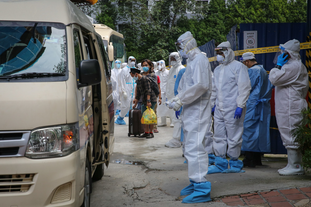 Foreign workers at a construction site in Jalan Ampang who came in close contact with Covid-19 patients board a bus and KKM van to a quarantine centre in Kuala Lumpur May 26, 2020. u00e2u20acu201d Picture by Yusof Mat Isa