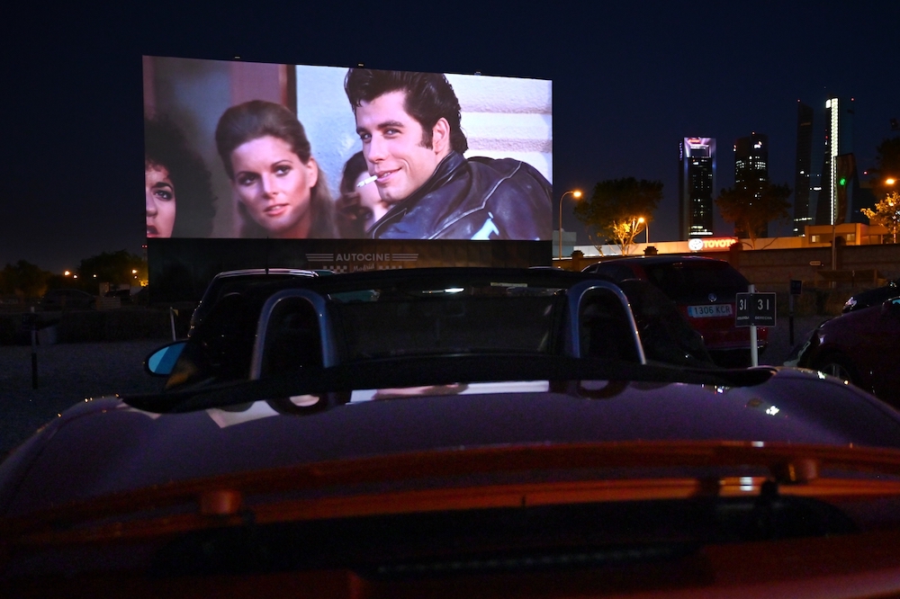 Cinema-goers in their cars attend the screening of the US musical romantic comedy film u00e2u20acu02dcGreaseu00e2u20acu2122 during the reopening of the Autocine Madrid Race drive-in cinema. u00e2u20acu201d AFP pic