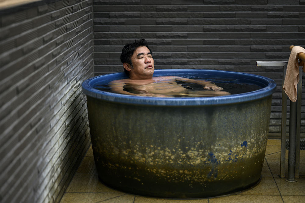 In this picture taken on May 29, 2020, Masazumi Kato relaxes in a Japanese hot spring tub in Yokohama, Kanagawa prefecture. u00e2u20acu201d AFP pic