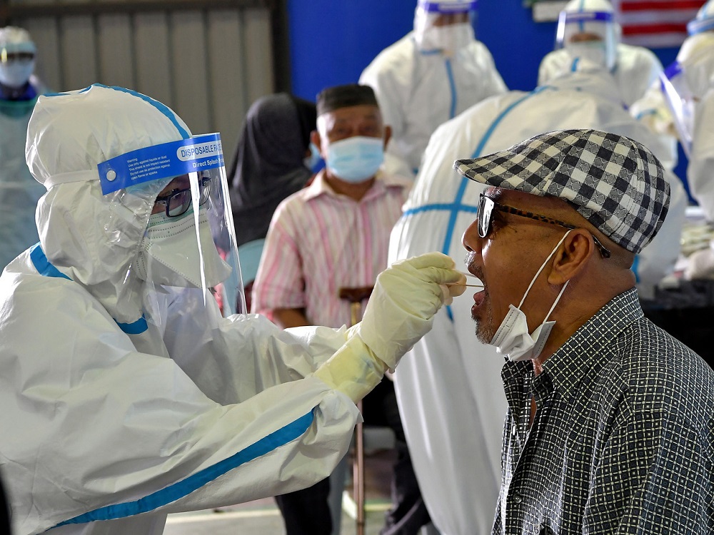 A man undergoes a swab test during a Covid-19 screening exercise at the Datuk Dr Wan Junaidi multipurpose hall in Tabuan Lot, Kuching May 9, 2020. u00e2u20acu201d Bernama pic