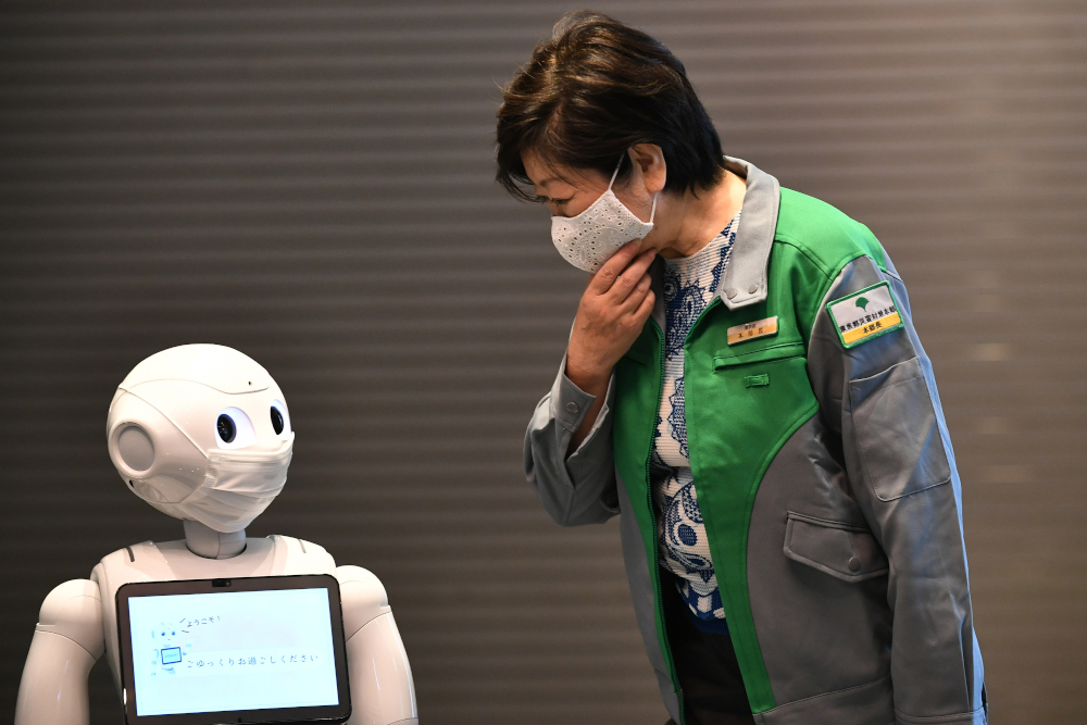 Tokyo governor Yuriko Koike looks at a greeting robot called u00e2u20acu02dcPepperu00e2u20acu2122 as she visits a hotel during an opening of a new medical lodging facilities to accommodate Covid-19 coronavirus patients with mild symptoms in Tokyo May 1, 2020. u00e2u20acu201d AFP pic 