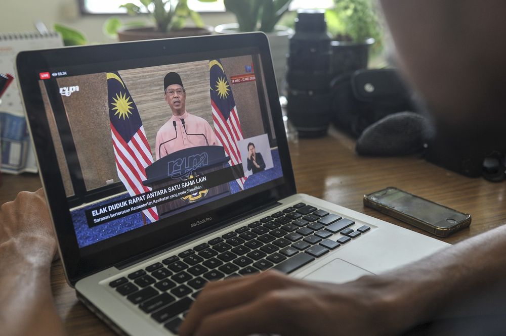 A man watch the live telecast of Prime Minister Tan Sri Muhyiddin Yassin speech about the conditional movement control order in Kuala Lumpur May 10, 2020. u00e2u20acu201d Picture by Shafwan Zaidon