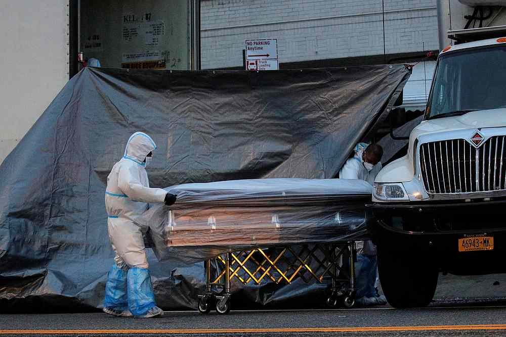 Workers roll a casket outside the Andrew T. Cleckley Funeral Services home, where it was found to be storing dead bodies in unrefrigerated U-Haul vehicles, in New York April 30, 2020. u00e2u20acu201d Reuters