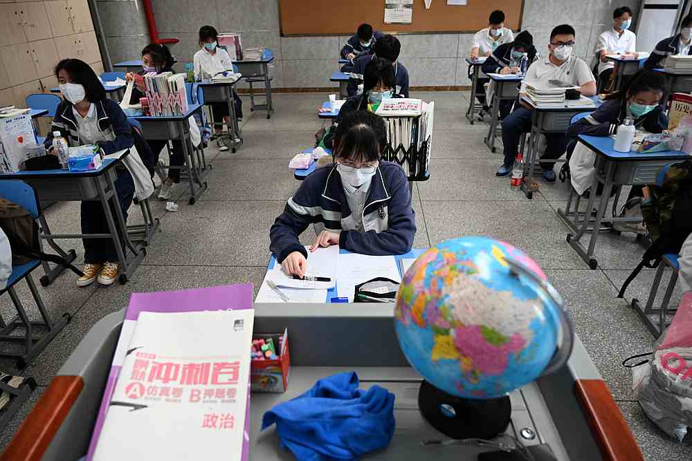 Senior high school students wearing face masks inside a classroom following the Covid-19 outbreak, in Wuhan, Hubei province, China May 6, 2020. u00e2u20acu201d China Daily pic via Reuters