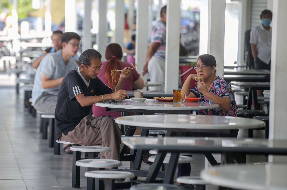 People catch a meal at Medan Selera Stadium Ipoh after the Perak state government lifted dine-in restrictions May 21, 2020. u00e2u20acu201d Picture by Farhan Najib