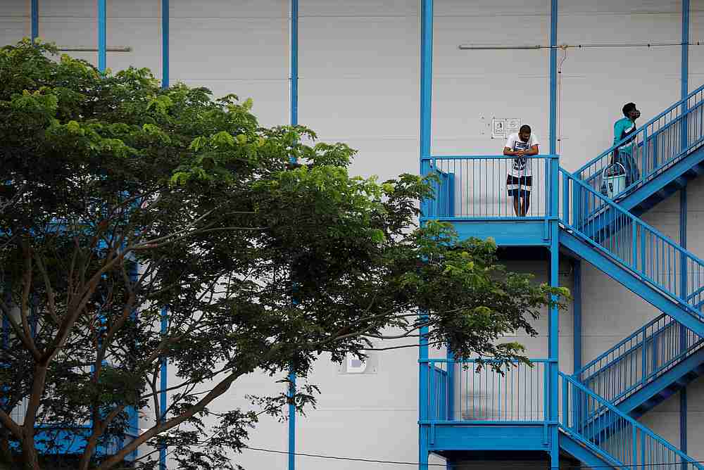 Migrant workers look on from their dormitory, declared as an isolation area, amid the Covid-19 outbreak in Singapore April 30, 2020. u00e2u20acu201d Reuters pic