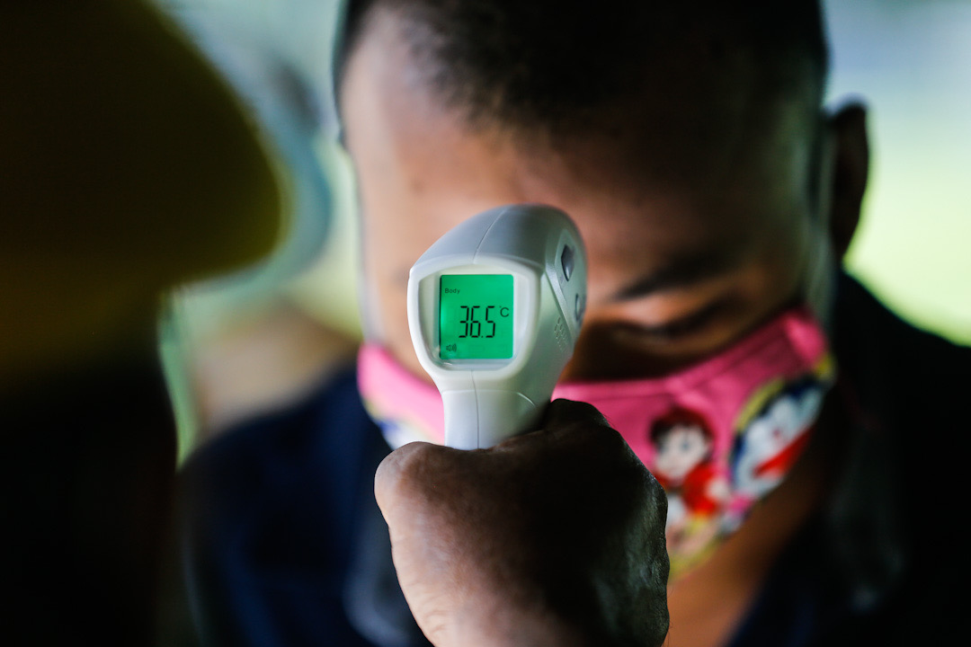 A foreign worker has his temperature taken during a Covid-19 screening exercise at Padang Polo, George Town May 14, 2020. u00e2u20acu201d Picture by Sayuti Zainudin