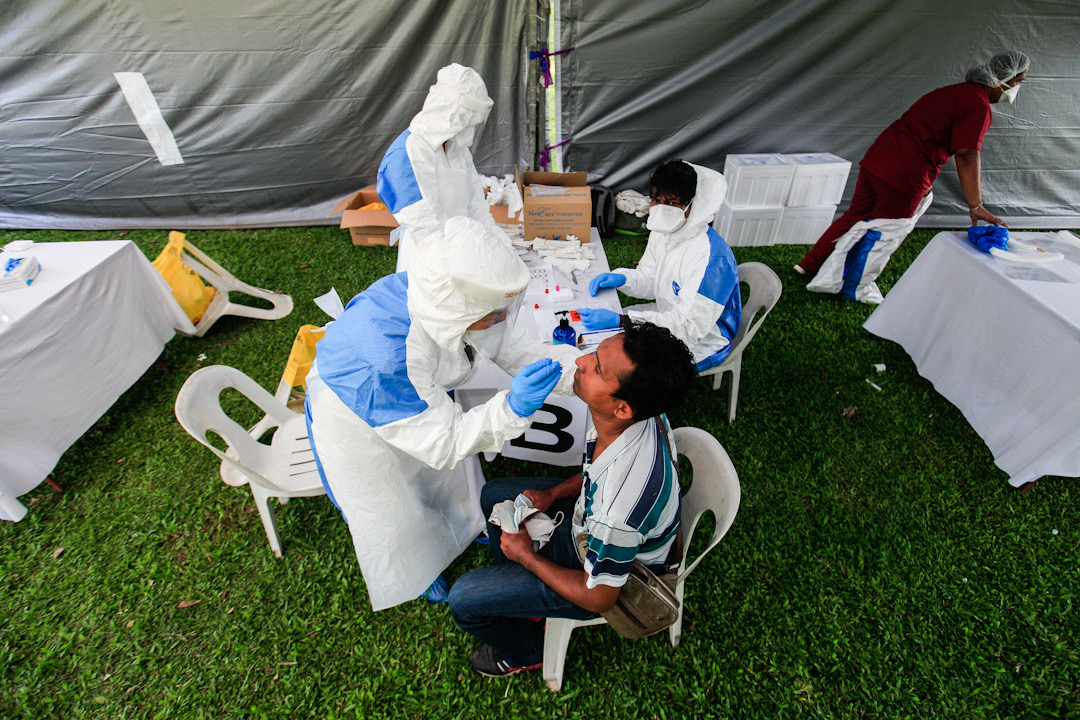A foreign worker undergoes a swab test during a Covid-19 screening exercise at Padang Polo, George Town May 14, 2020. u00e2u20acu201d Picture by Sayuti Zainudin
