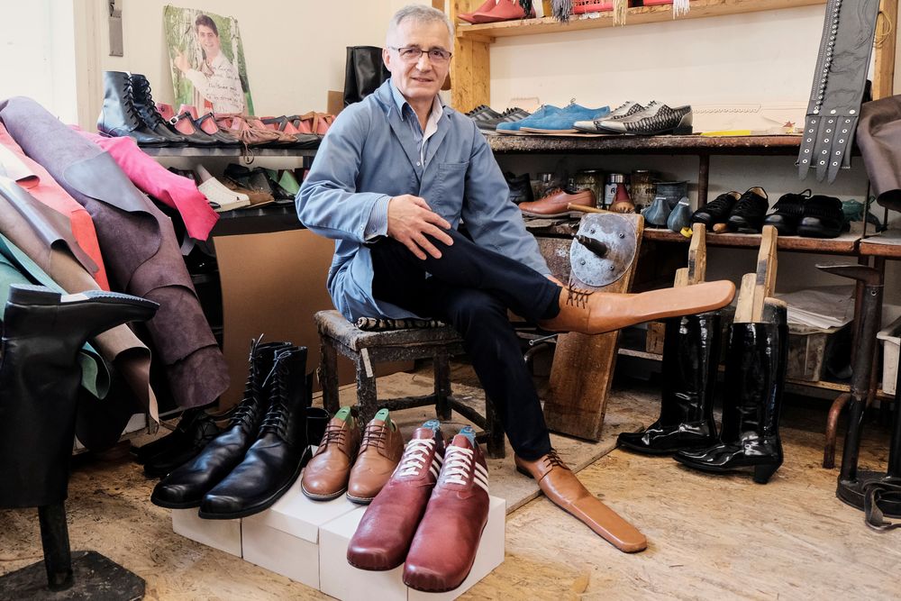 Shoemaker Grigore Lup poses for a portrait while showcasing a pair of his long-nosed leather shoes to help keeping social distance, amid the outbreak of the coronavirus disease, in Cluj-Napoca, Romania, May 29, 2020. u00e2u20acu201d Inquam Photos via Reuters