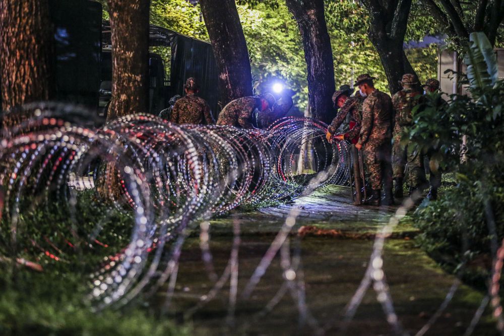 Armed Forces personnel erect barbed wire fencing in Taman Wilayah Selayang after it was placed under the enhanced movement control order on May 4, 2020. u00e2u20acu201d Picture by Hari Anggara