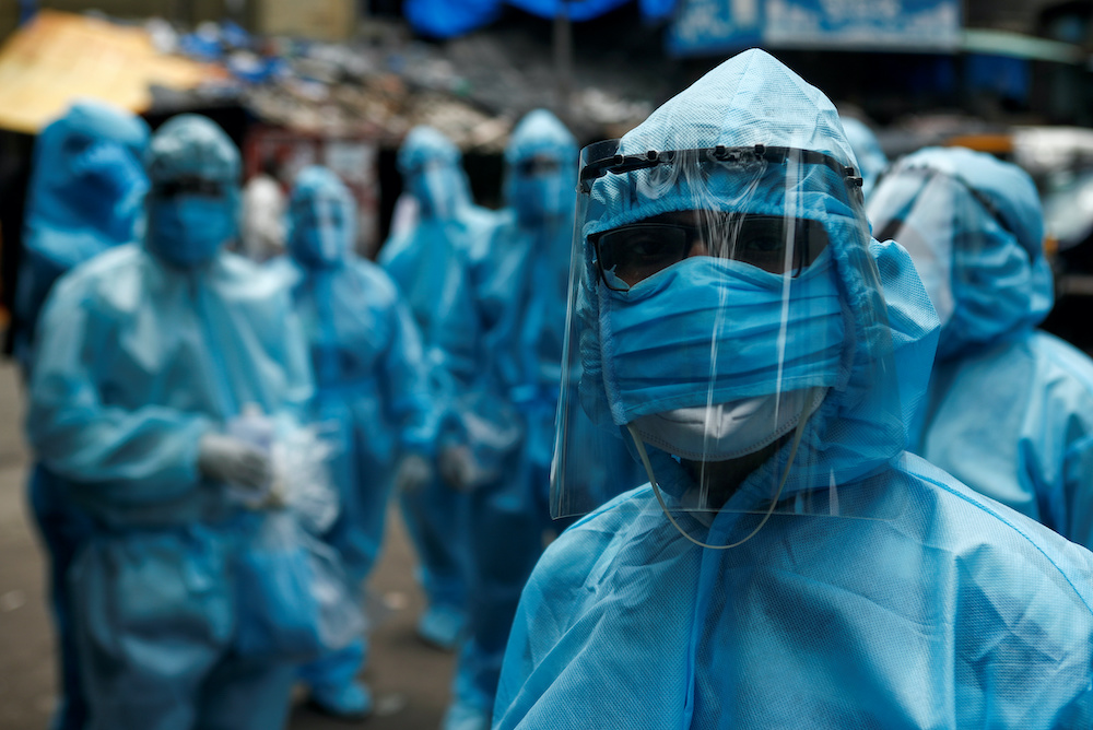 Healthcare workers wait to take off their personal protective equipment (PPE) after the end of a check-up camp for the coronavirus disease (Covid-19) at a slum in Mumbai, India June 14, 2020. u00e2u20acu201d Reuters pic
