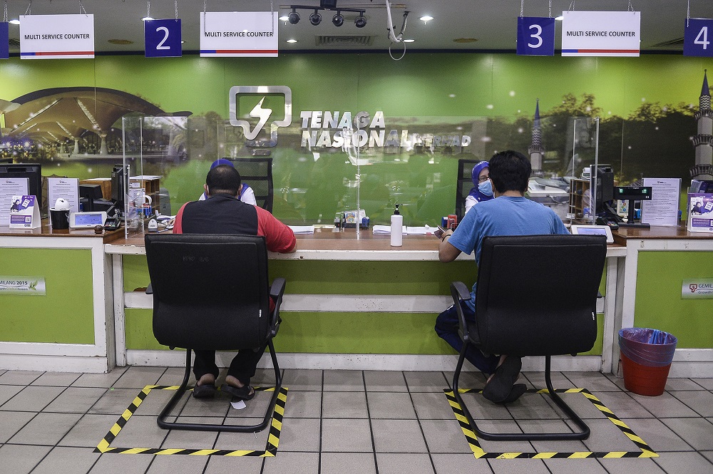 Customers paying their bills at the Kedai Tenaga branch in Shah Alam June 2, 2020. u00e2u20acu201d Picture by Miera Zulyana